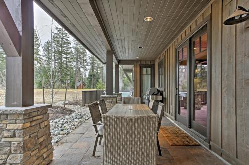 a patio with a table and chairs on a house at Cle Elum Home on Golf Course with Fire Pit and Hot Tub in Cle Elum