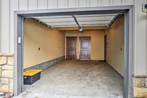 an empty garage with two doors and a bench at Red Lodge Townhome with Private Hot Tub and Mtn Views! in Red Lodge