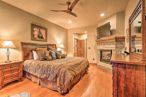 a bedroom with a large bed and a fireplace at Red Lodge Townhome with Private Hot Tub and Mtn Views! in Red Lodge