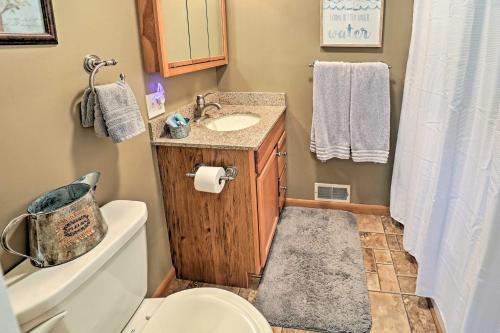 a small bathroom with a sink and a toilet at Auburn Vacation Rental Home Near Owasco Lake! in Auburn