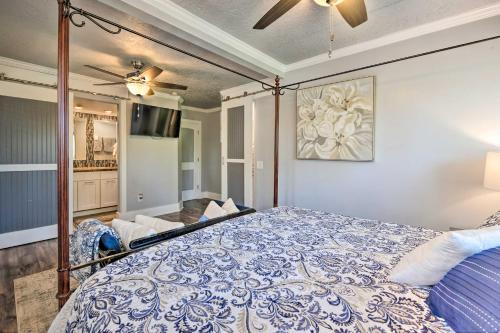a bedroom with a blue and white bed with a ceiling fan at Charming Historic Ogden Home with Private Backyard! in Ogden