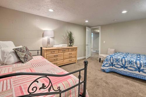 a bedroom with two beds and a dresser at Charming Historic Ogden Home with Private Backyard! in Ogden