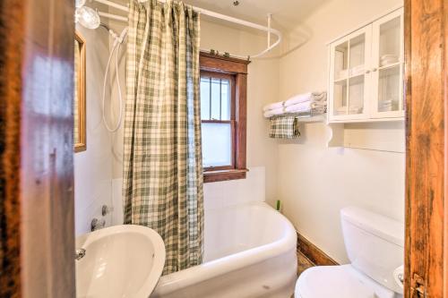 a bathroom with a tub and a toilet and a sink at Charming Urbana Home Near Downtown! in Urbana