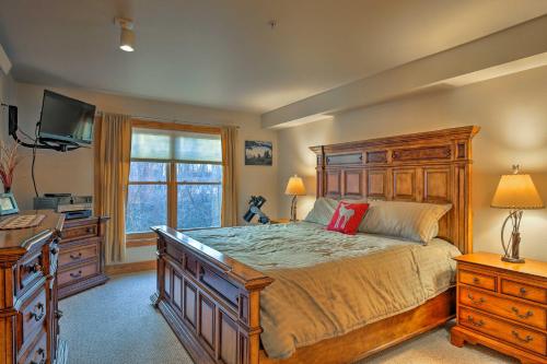 a bedroom with a bed and a desk and a television at Cozy Driggs Condo with Hot Tub and Ski Shuttle Service in Driggs