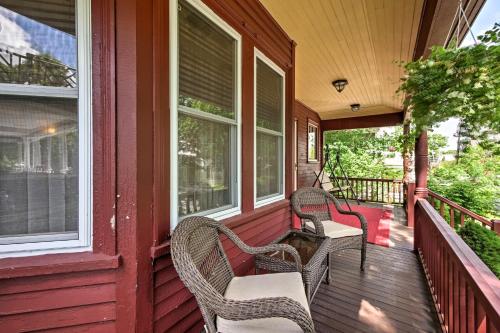 a porch with wicker chairs and windows on a house at Central Bar Harbor Home, Walk to the Shore and Town! in Bar Harbor