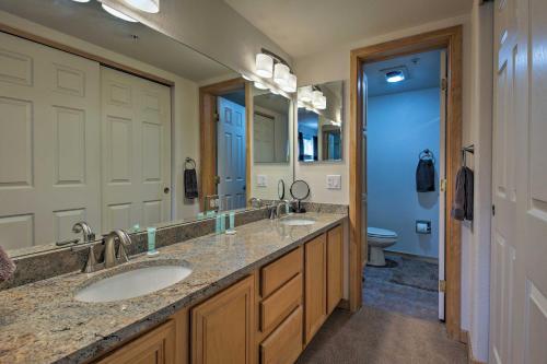 a bathroom with two sinks and a large mirror at 360 Mtn Views and Shared Hot Tub Cozy Frisco Condo! in Frisco