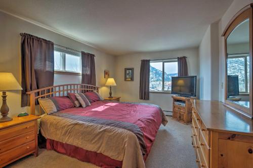 a bedroom with a bed and a flat screen tv at 360 Mtn Views and Shared Hot Tub Cozy Frisco Condo! in Frisco