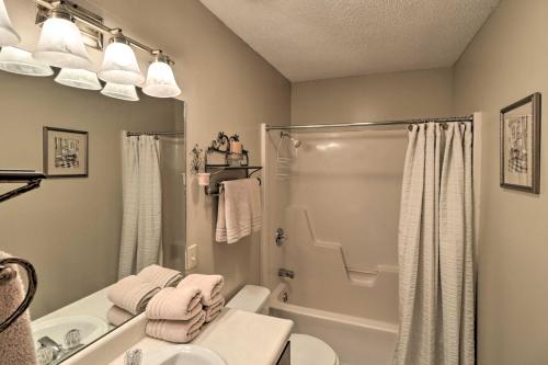 a bathroom with a shower and a toilet and a sink at Lake Ozark Condo with Pool and Fishing Docks! in Lake Ozark