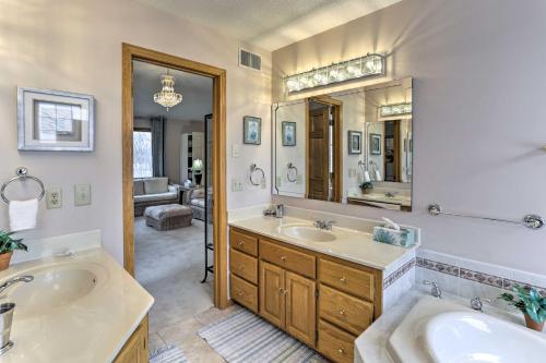 a bathroom with two sinks and a large mirror at Eagan Home with Porch - 5 Mi to Mall of America! in Eagan