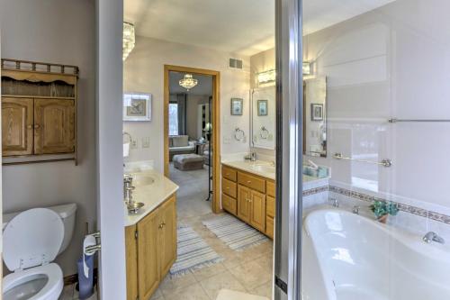 a bathroom with a tub and a toilet and a sink at Eagan Home with Porch - 5 Mi to Mall of America! in Eagan