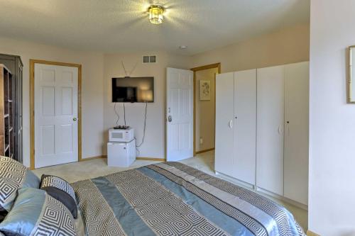 a bedroom with a bed and a television in it at Eagan Home with Porch - 5 Mi to Mall of America! in Eagan