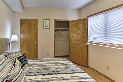 a bedroom with a bed and a large window at Eagan Home with Porch - 5 Mi to Mall of America! in Eagan