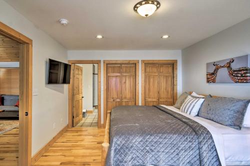 a bedroom with a bed and a flat screen tv at Cabin with Hot Tub and Mountain Views Less Than 5 Mi to Boone in Blowing Rock