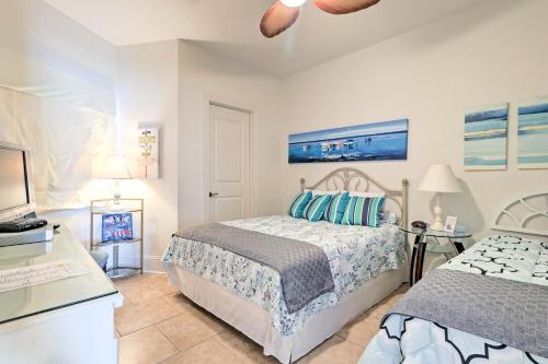 a bedroom with two beds and a television in it at Beachfront Condo with Pool Access in Biloxi! in Biloxi