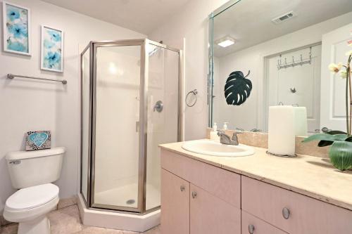 a bathroom with a shower and a toilet and a sink at Beachfront Condo with Pool Access in Biloxi! in Biloxi