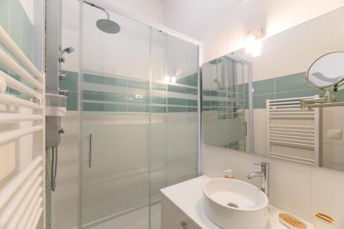 a bathroom with a sink and a glass shower at Daumier - New 2 Bdrs Flat near la Seine in Paris