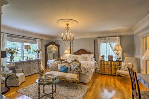 a bedroom with a large bed and a chandelier at Historic Cedar Hill Mansion on Large Farm with Pool! in Pleasant View