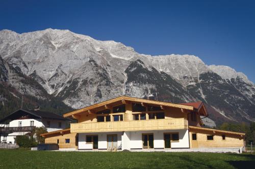 a building with a mountain in the background at Alpenchalet im Leutaschtal in Leutasch