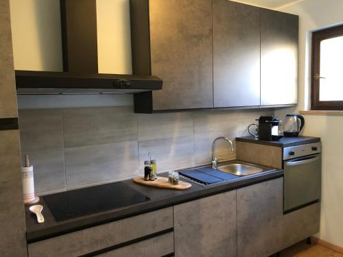 a kitchen with a sink and a counter top at Trento House in Trento
