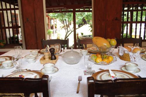 a table with a white table cloth with food on it at CASA SINNING-año1637 in Mompos