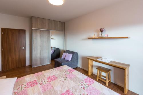 1 dormitorio con cama, escritorio y silla en Apartment Chamonix PRIMO, en Starý Smokovec