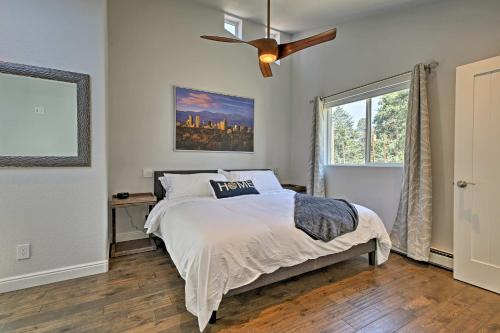 een slaapkamer met een bed en een plafondventilator bij Modern Morrison House with Deck and 2 Fireplaces! in Morrison