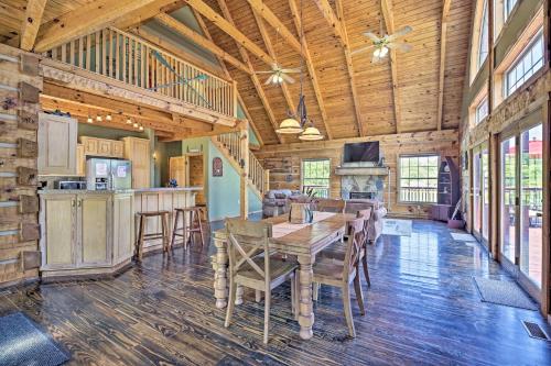 a dining room and kitchen in a log home at Cherokee Lake Cabin with Deck and Kayaks! in Bean Station