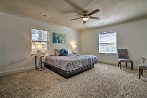 a bedroom with a bed and two chairs and a ceiling fan at Comfortable Ranch Home - 5 Mi to Downtown Atlanta! in Atlanta