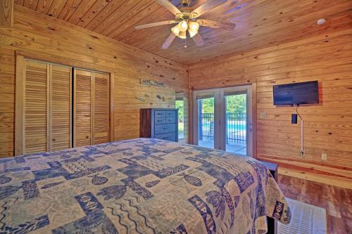 a bedroom with a bed and a ceiling fan at Cherokee Lake Cabin with Deck and Kayaks! in Bean Station
