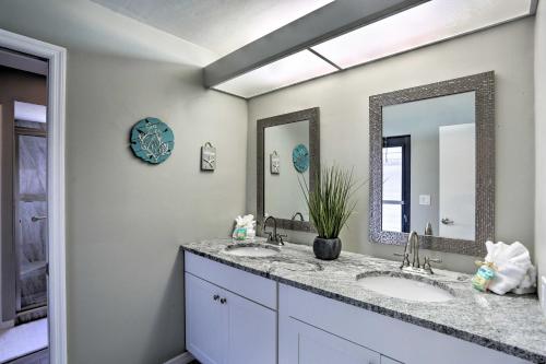 a bathroom with two sinks and a mirror at Cape Coral Home with Heated Pool, Dock and Gulf Access in Cape Coral