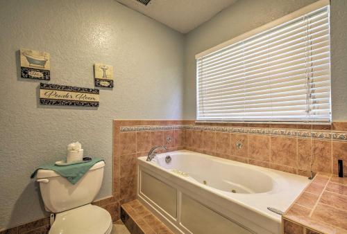 a bathroom with a tub and a toilet and a sink at 1 Mi to Weeki Wachee Home with Pool in Spring Hill in Spring Hill