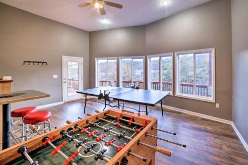 a games room with a ping pong table and chairs at Family-Friendly Massanutten Home with Slope Views! in McGaheysville