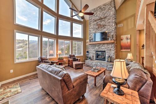a living room with leather furniture and a large window at Family-Friendly Massanutten Home with Slope Views! in McGaheysville