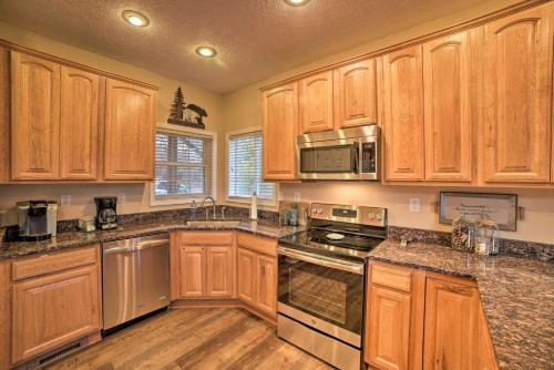 a kitchen with wooden cabinets and stainless steel appliances at Family-Friendly Massanutten Home with Slope Views! in McGaheysville