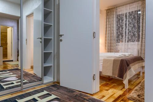 a bedroom with a bed and a glass wall at Konačište Dabić in Zlatibor