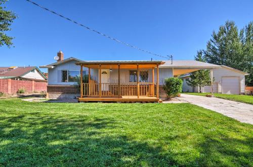 a house with a large wooden porch in a yard at Cottage Near Bryce Canyon and Zion National Parks! in Cannonville