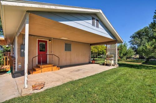 a house with a porch and a red door at Cottage Near Bryce Canyon and Zion National Parks! in Cannonville