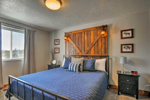 a bedroom with a blue bed with a wooden headboard at Luxe Home about 2 Mi to Bryce Canyon National Park! in Bryce Canyon