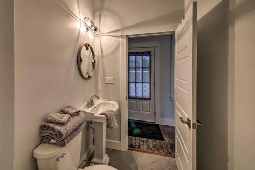 a white bathroom with a sink and a toilet at Lakefront Studio Guest Home on Hermann Wine Trail! in New Haven