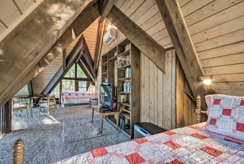 an attic bedroom with a bed and a desk at Brevard Chalet with Stunning Blue Ridge Mtn Views! in Brevard