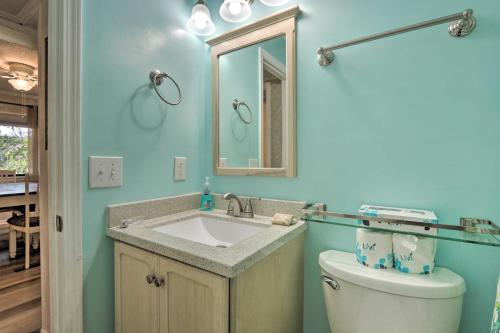 a bathroom with a sink and a toilet and a mirror at Walk to Beach Hilton Head Condo with Balcony in Hilton Head Island