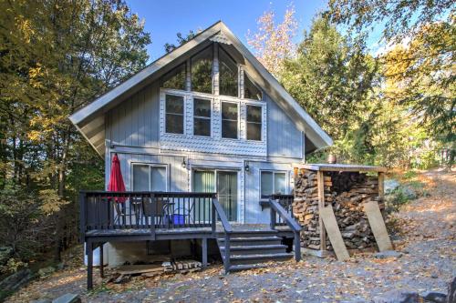 a tiny house in the woods with a porch at Gilford Cabin - 2 Mi to Gunstock Mountain Resort! in Gilford