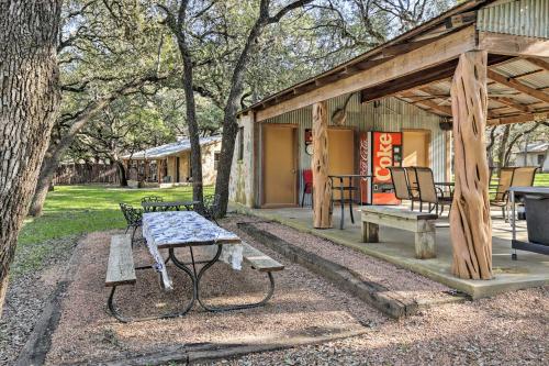 a picnic table and benches in a park at Blanco Riverfront Historic Home, 3 Mi to Downtown! in Blanco