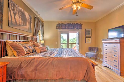 a bedroom with a bed and a ceiling fan at Beautiful Bryson City Home with Hot Tub and Mtn Views! in Bryson City
