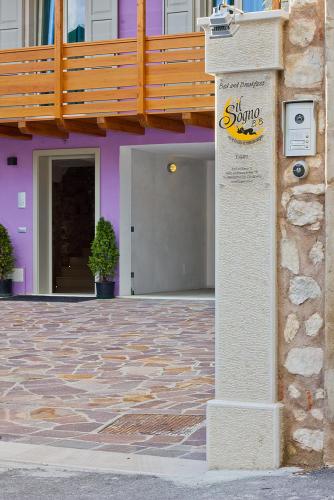 a building with a sign on the side of it at Il Sogno in Avio