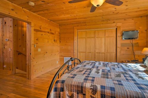 a bedroom with a bed and a ceiling fan at Beautiful Bryson City Home with Hot Tub and Mtn Views! in Bryson City