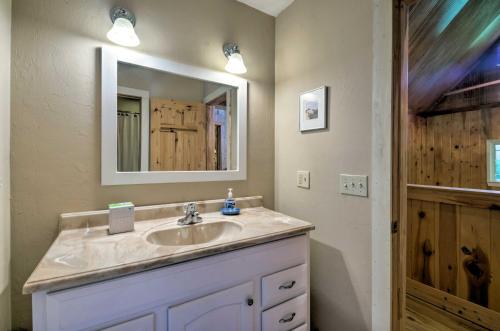 a bathroom with a sink and a mirror at Beautiful Bryson City Home with Hot Tub and Mtn Views! in Bryson City