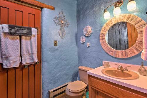 a bathroom with a sink and a mirror at El Prado Adobe Home Courtyard with Mountain Views! in El Prado