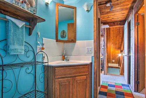 a bathroom with a sink and a mirror at Lakefront Montague Cottage with Deck and Beach! in Rothbury
