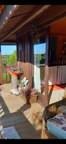 a porch of a house with a table and flowers at Ying Yang Monte da Lua in Comporta